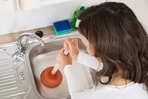 unblocking sink with a plunger